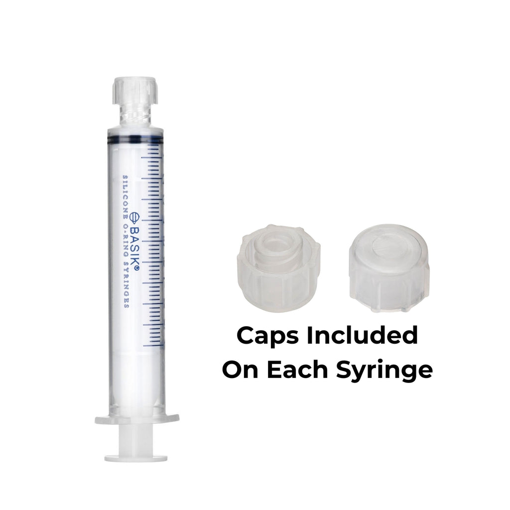 A clear plastic syringe with blue measurement markings and text reading 'SILICONE O-Ring SYRINGES' on the barrel, shown alongside two white syringe caps and the text 'Caps Included On Each Syringe' on a plain white background.
